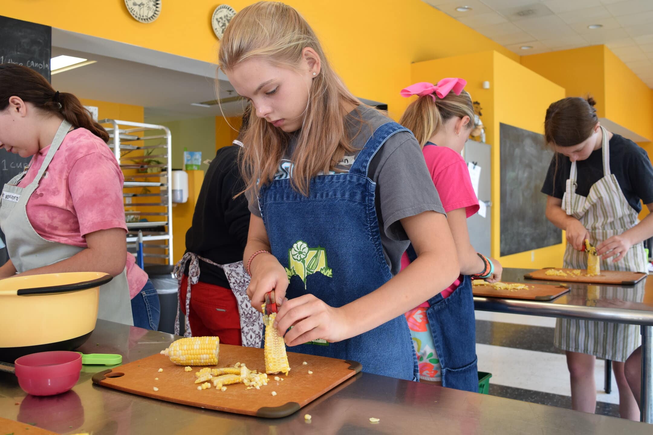 Children cooking in educational kitchen activity.