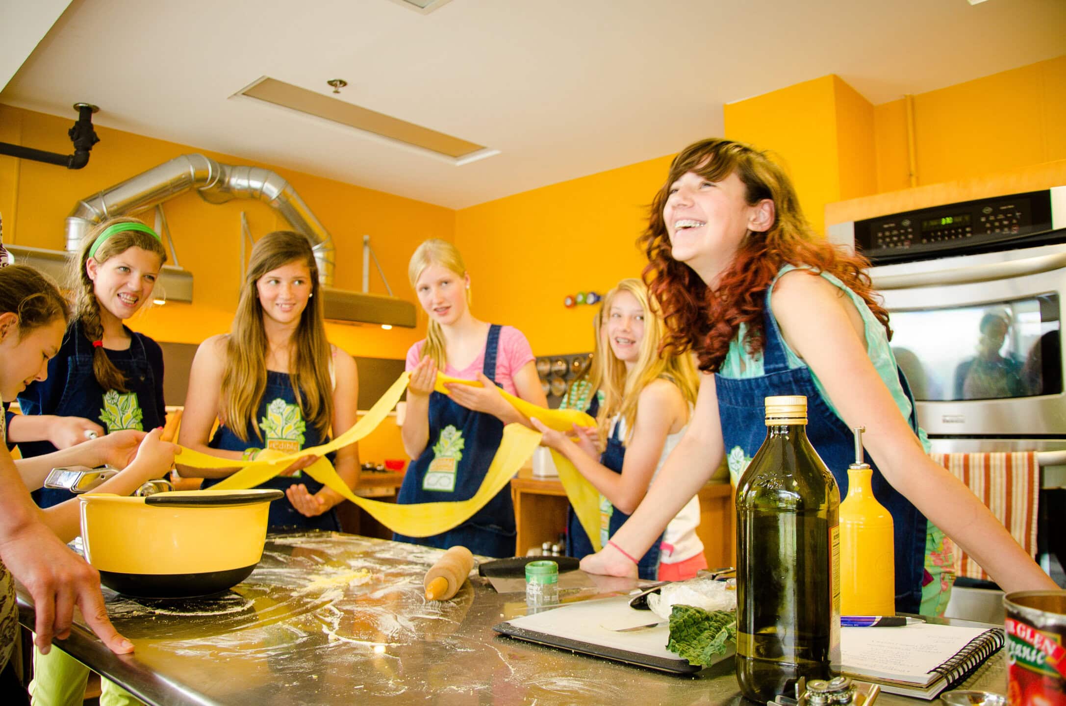 Children cooking with red peppers at miriam p. Brenner children's museum.