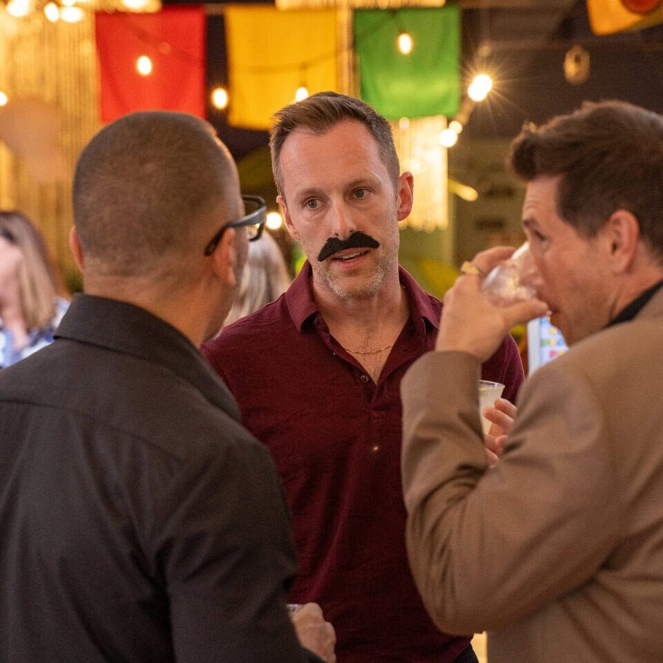 Adults socializing at miriam p. Brenner children's museum gala event.