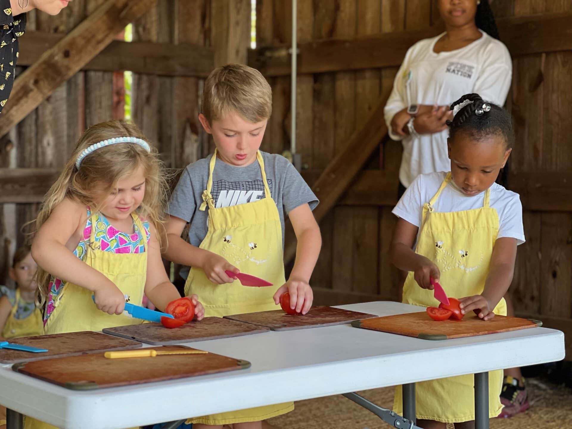 Children cooking with red peppers at miriam p. Brenner children's museum.